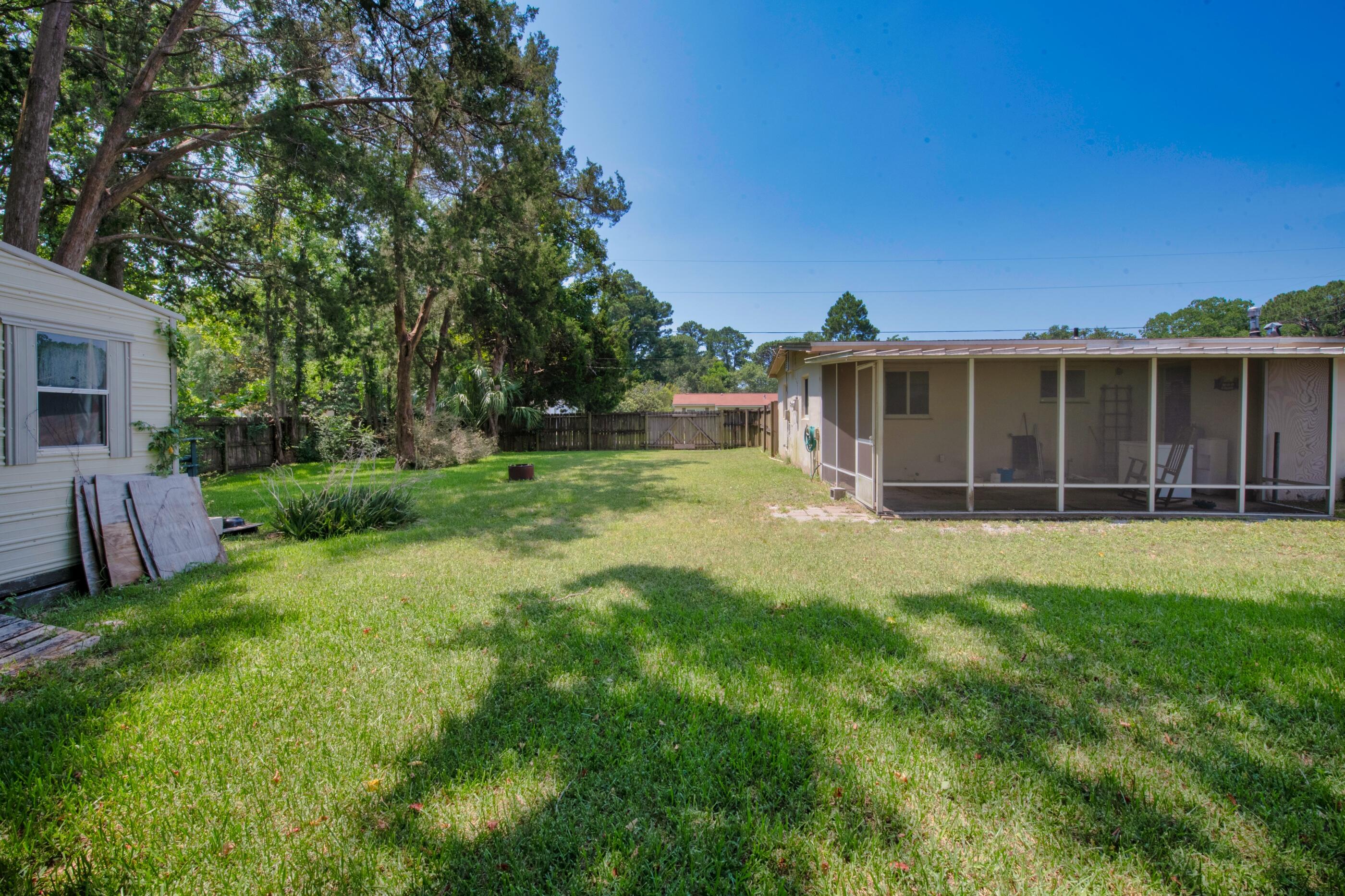 600 Shrewsbury Road Mary Esther, FL 32569 - Photo 23 of 25 a view of a house with backyard sitting area and garden