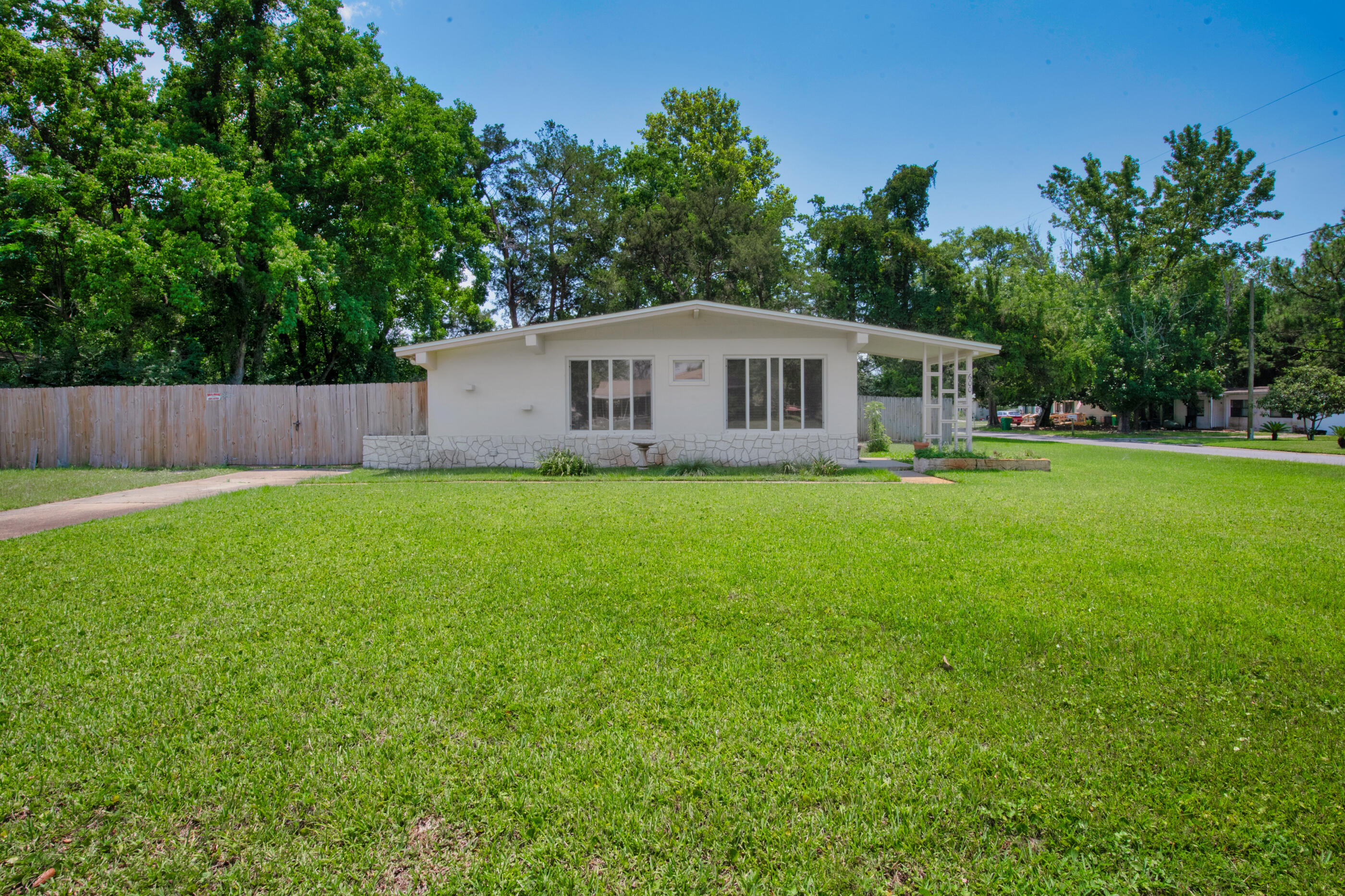 600 Shrewsbury Road Mary Esther, FL 32569 - Photo 4 of 25 a view of a house with a yard and a porch