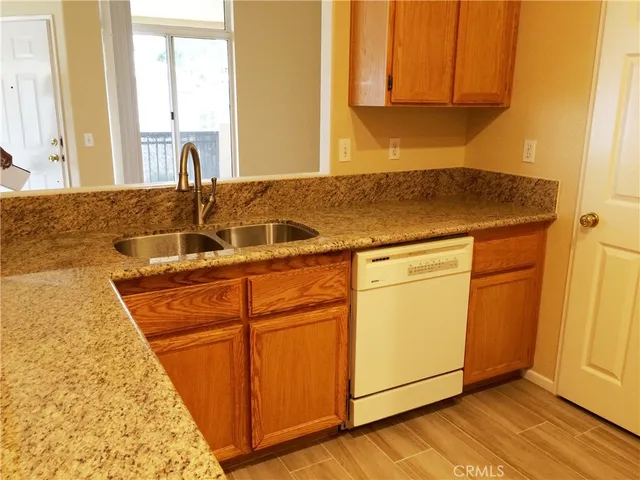 a kitchen with granite countertop a sink and cabinets
