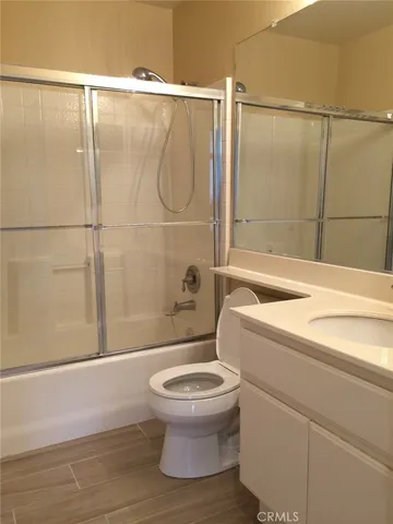 a bathroom with a double vanity sink toilet and shower