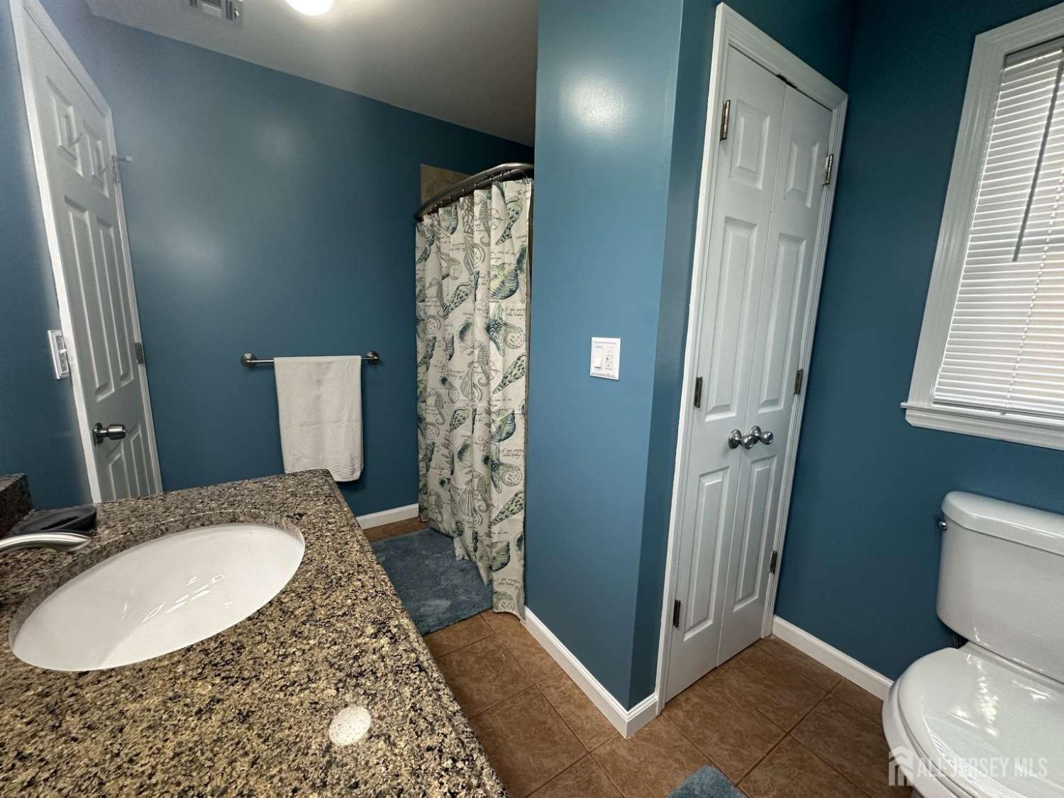 207 Remsen Avenue Avenel, NJ 07001 - Photo 14 of 24 a bathroom with a granite countertop sink toilet and shower