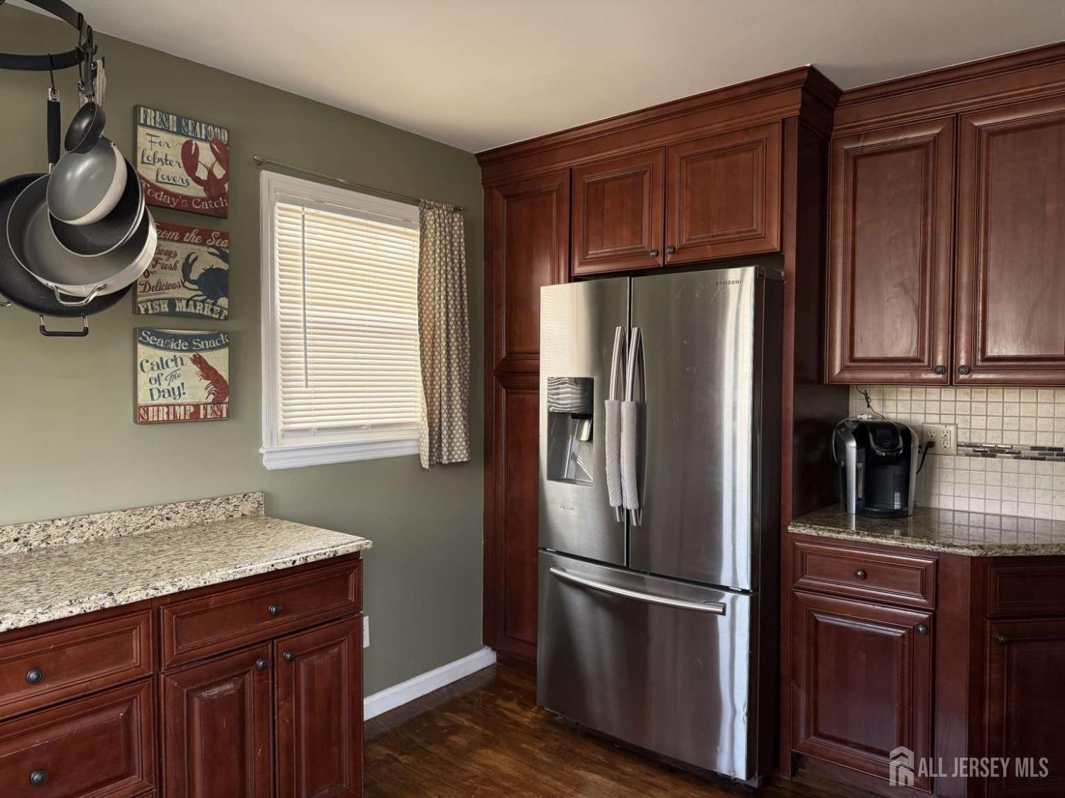 207 Remsen Avenue Avenel, NJ 07001 - Photo 6 of 24 a kitchen with stainless steel appliances granite countertop a refrigerator sink and cabinets