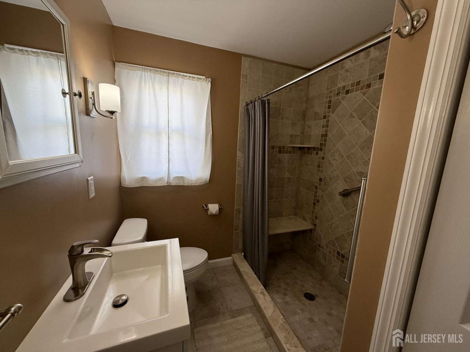 207 Remsen Avenue Avenel, NJ 07001 - Photo 8 of 24 a bathroom with a shower and a sink