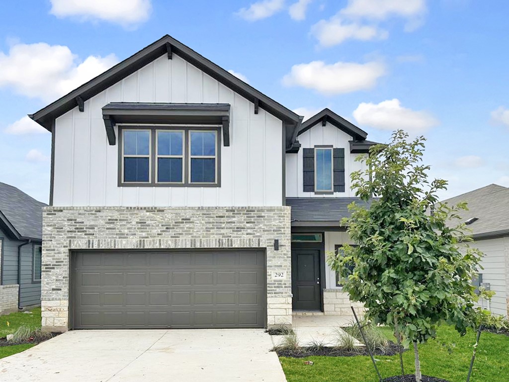 a front view of a house with garage