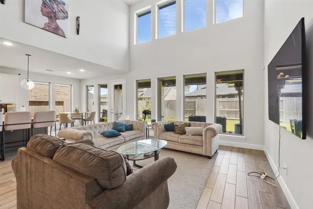 a living room with furniture and large windows