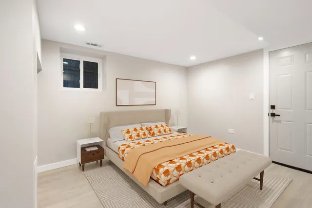 a bedroom with a bed and a window