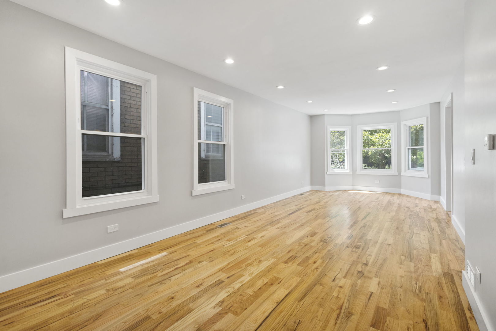 6129 North Ravenswood Avenue, Unit 1 Chicago, IL 60660 - Photo 3 of 33 a view of empty room with wooden floor and fan