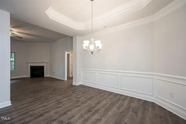 an empty room with windows and fireplace