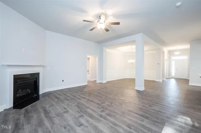 an empty room with fan and windows