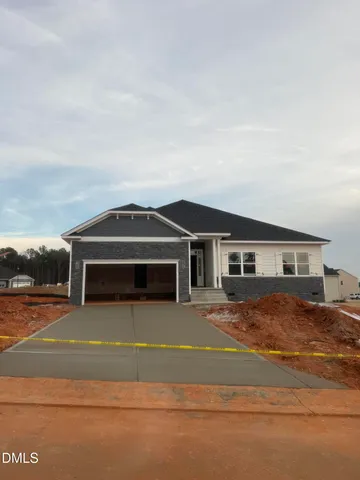 a view of a house with a big yard and large trees