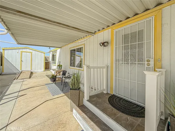 a view of a dining room with furniture and a potted plant