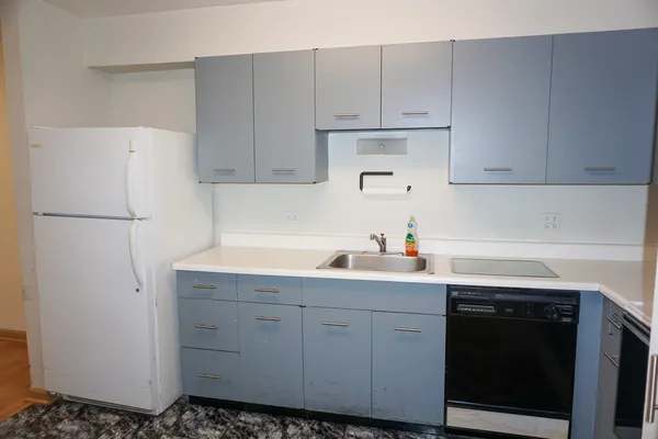 a kitchen with a sink and white cabinets