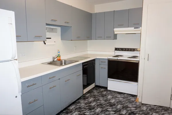 a kitchen with a sink stove and cabinets