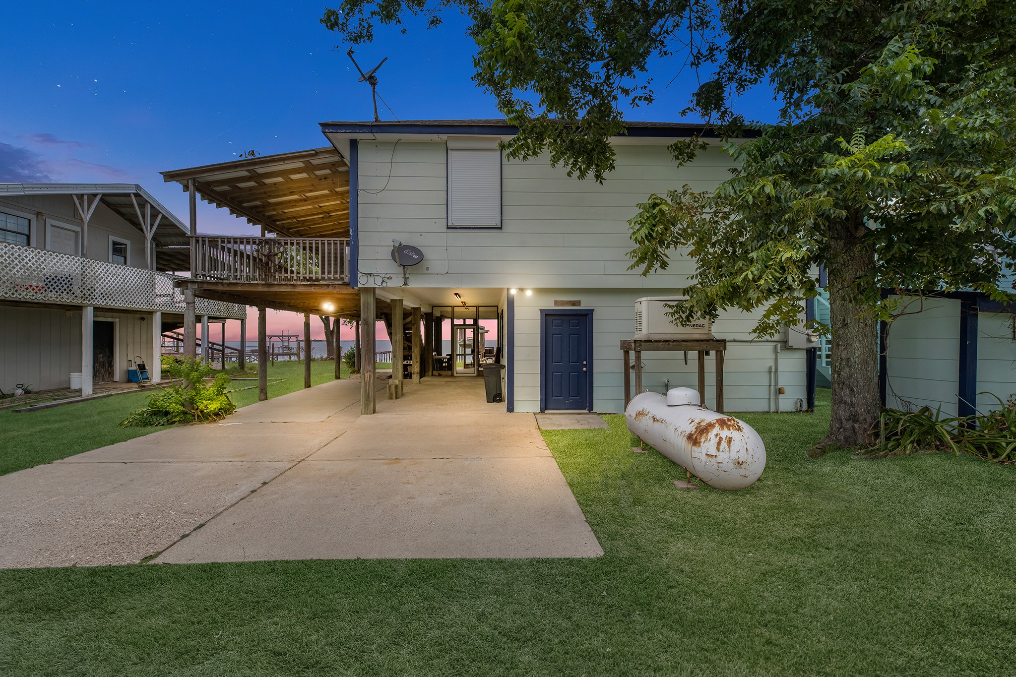 211 Captains Road Anahuac, TX 77514 - Photo 11 of 39 a front view of a house with a garden