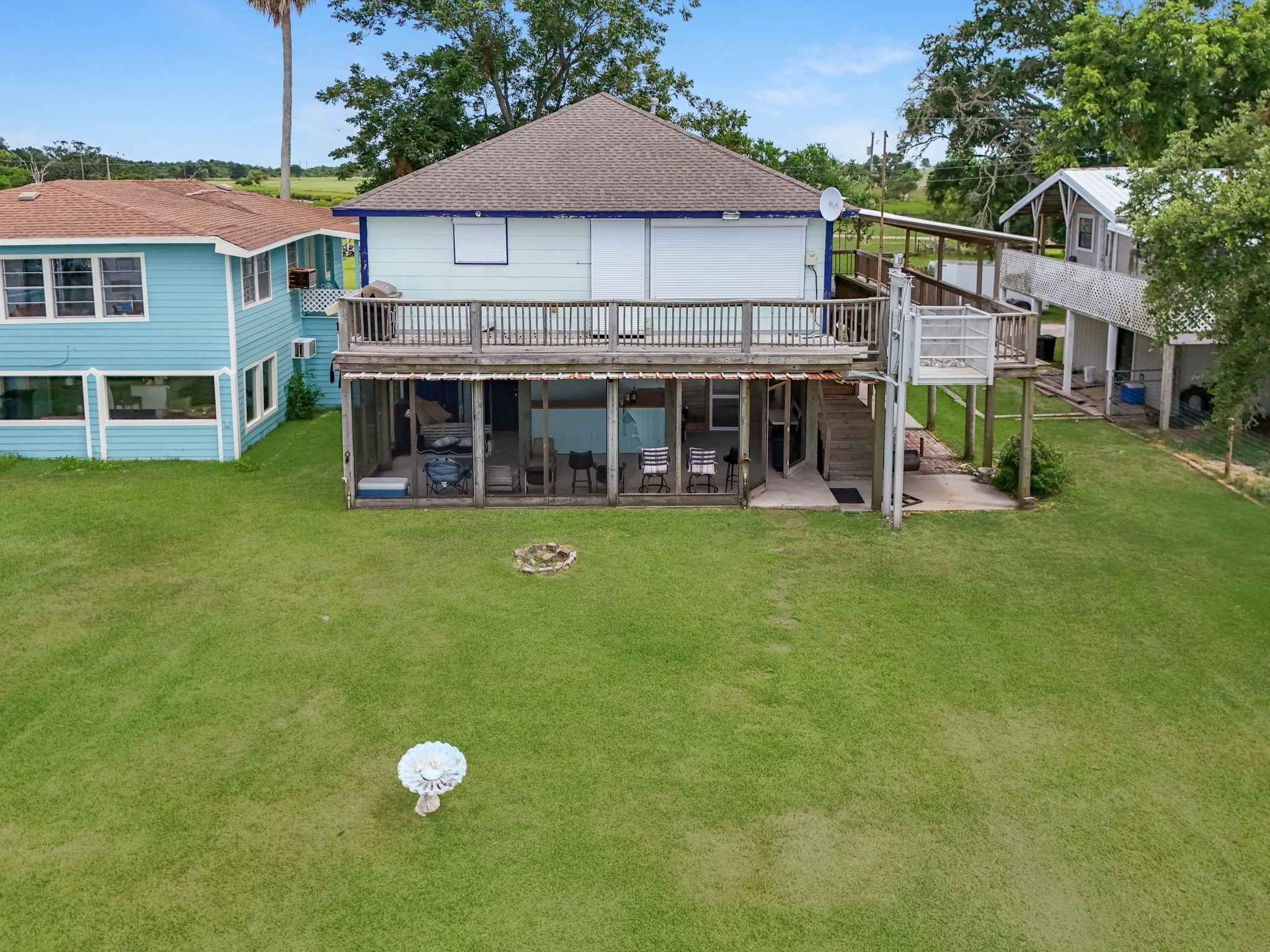 211 Captains Road Anahuac, TX 77514 - Photo 12 of 39 a view of a house with a backyard porch and sitting area