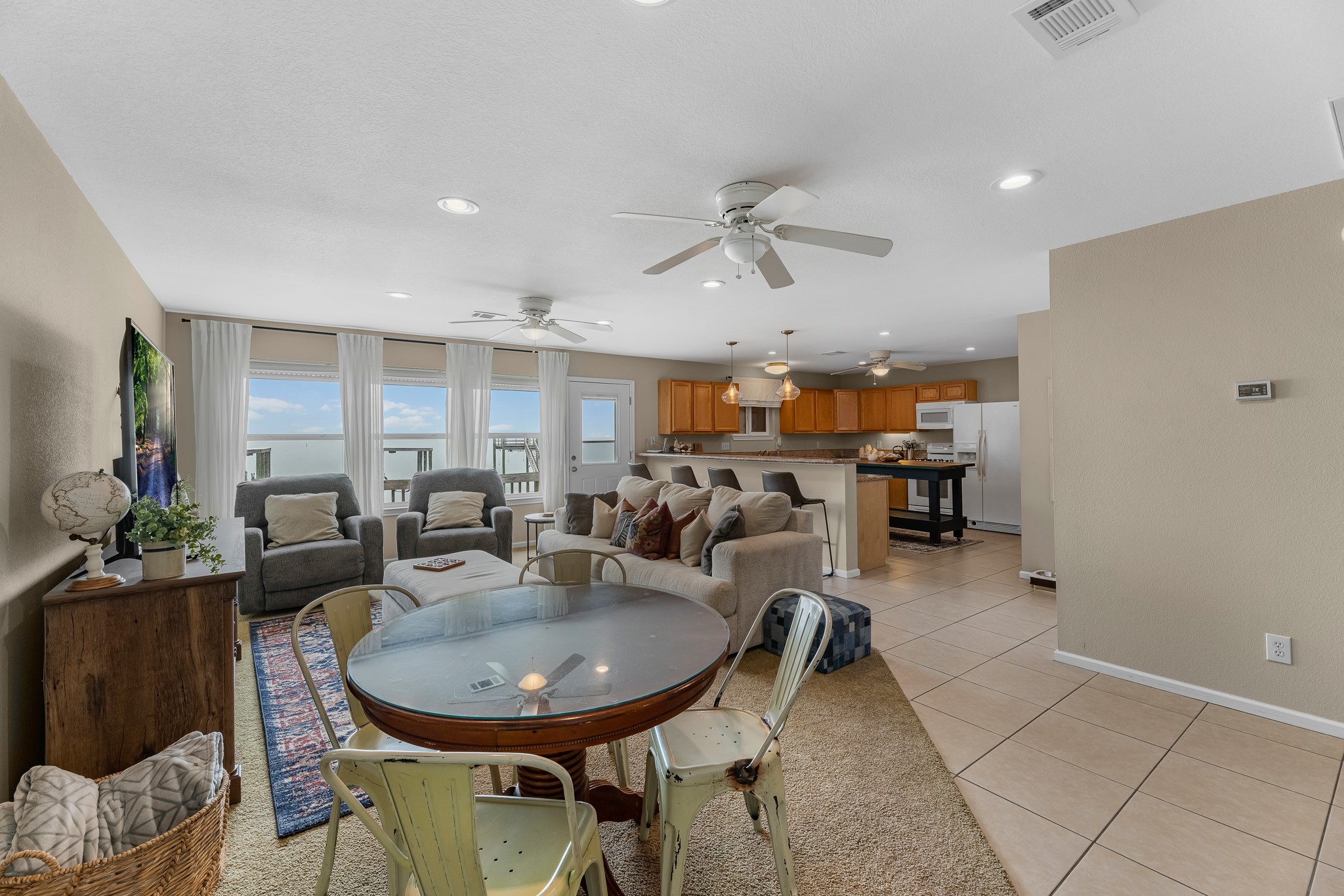 211 Captains Road Anahuac, TX 77514 - Photo 17 of 39 a living room with furniture and a chandelier