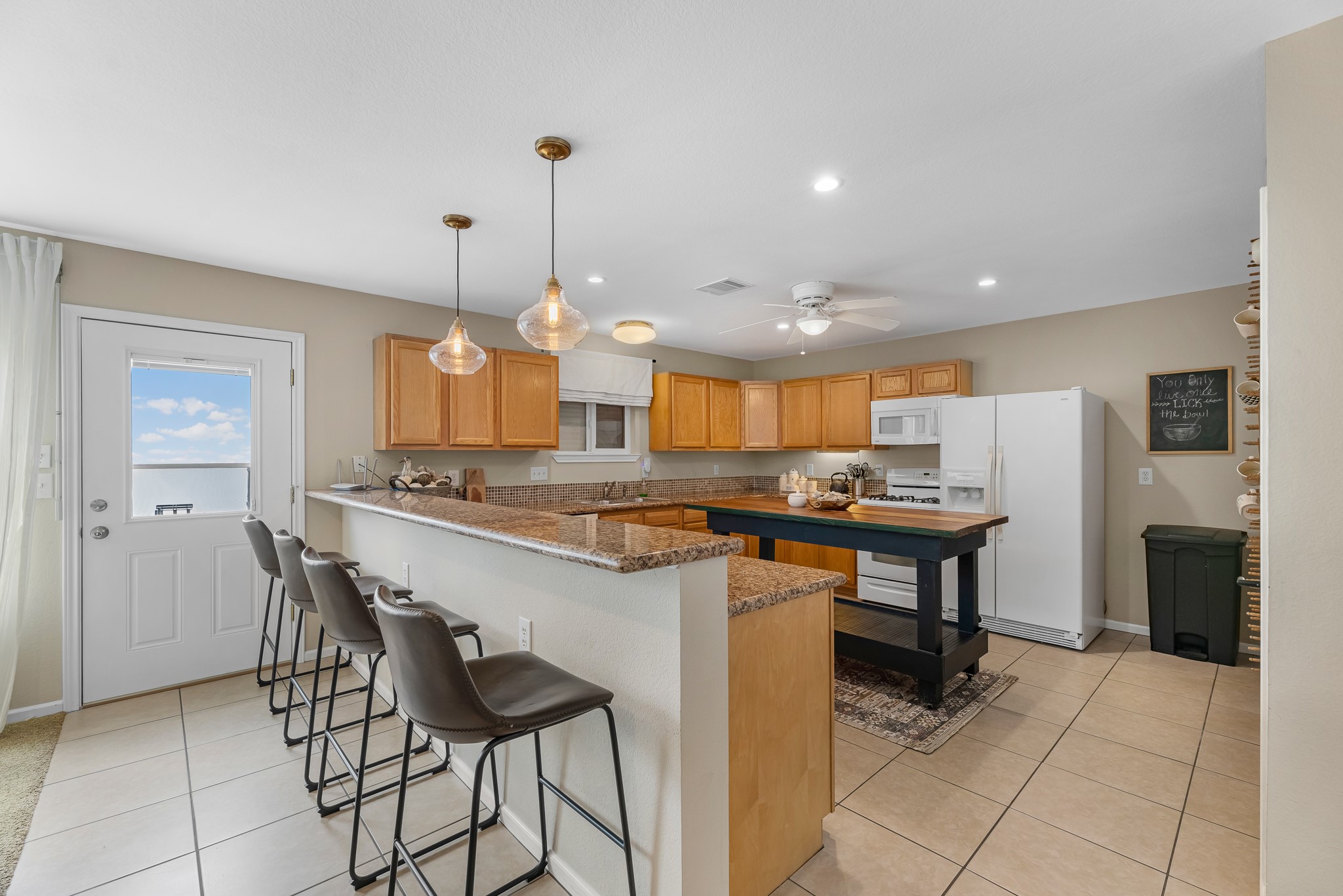 211 Captains Road Anahuac, TX 77514 - Photo 21 of 39 a kitchen with a table and chairs in it
