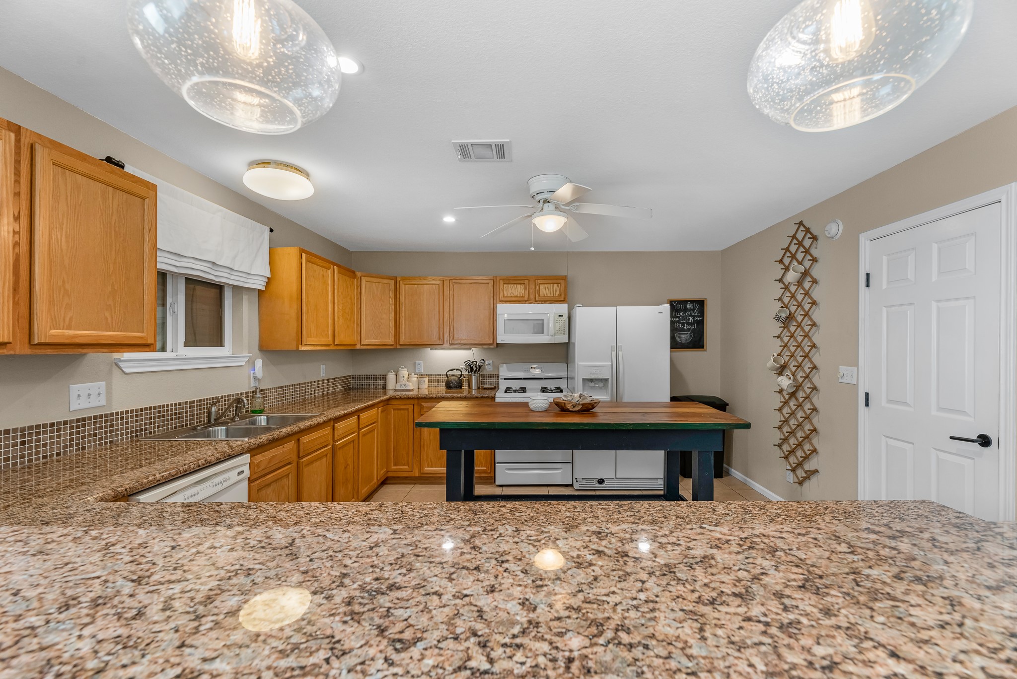 211 Captains Road Anahuac, TX 77514 - Photo 22 of 39 a large kitchen with kitchen island stainless steel appliances a stove and a refrigerator
