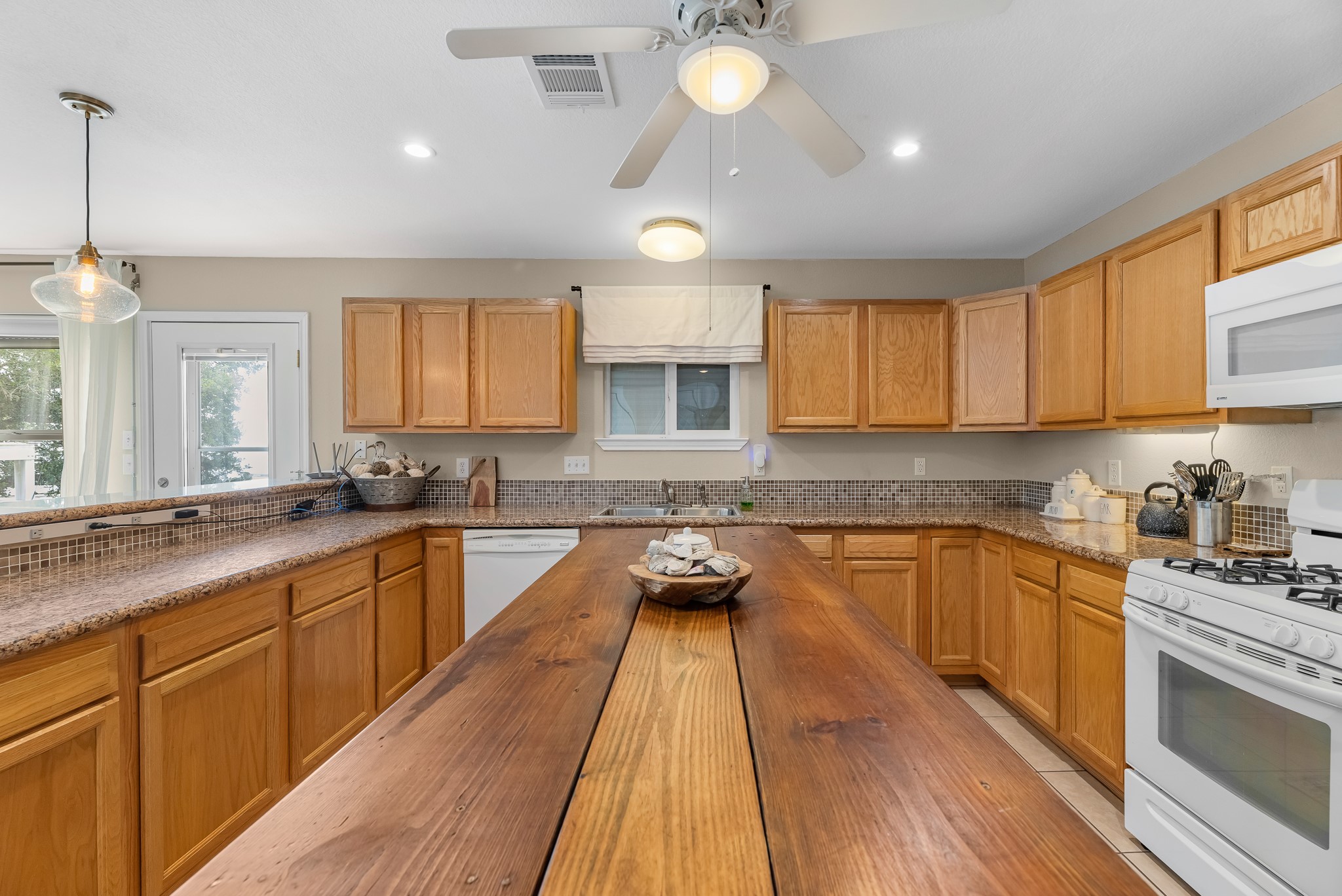 211 Captains Road Anahuac, TX 77514 - Photo 23 of 39 a kitchen with granite countertop a sink a counter space appliances and cabinets