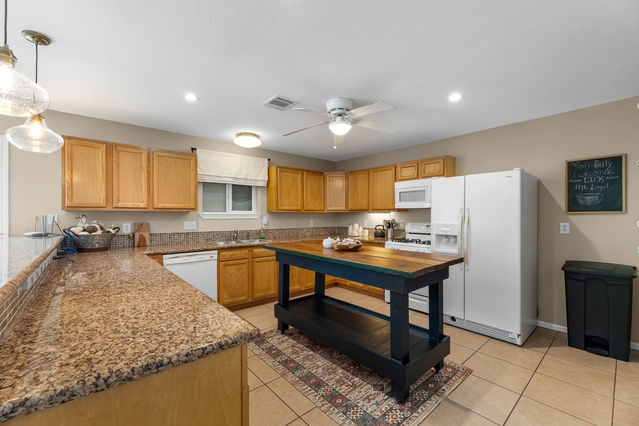 211 Captains Road Anahuac, TX 77514 - Photo 24 of 39 a kitchen with stainless steel appliances granite countertop a sink stove and refrigerator
