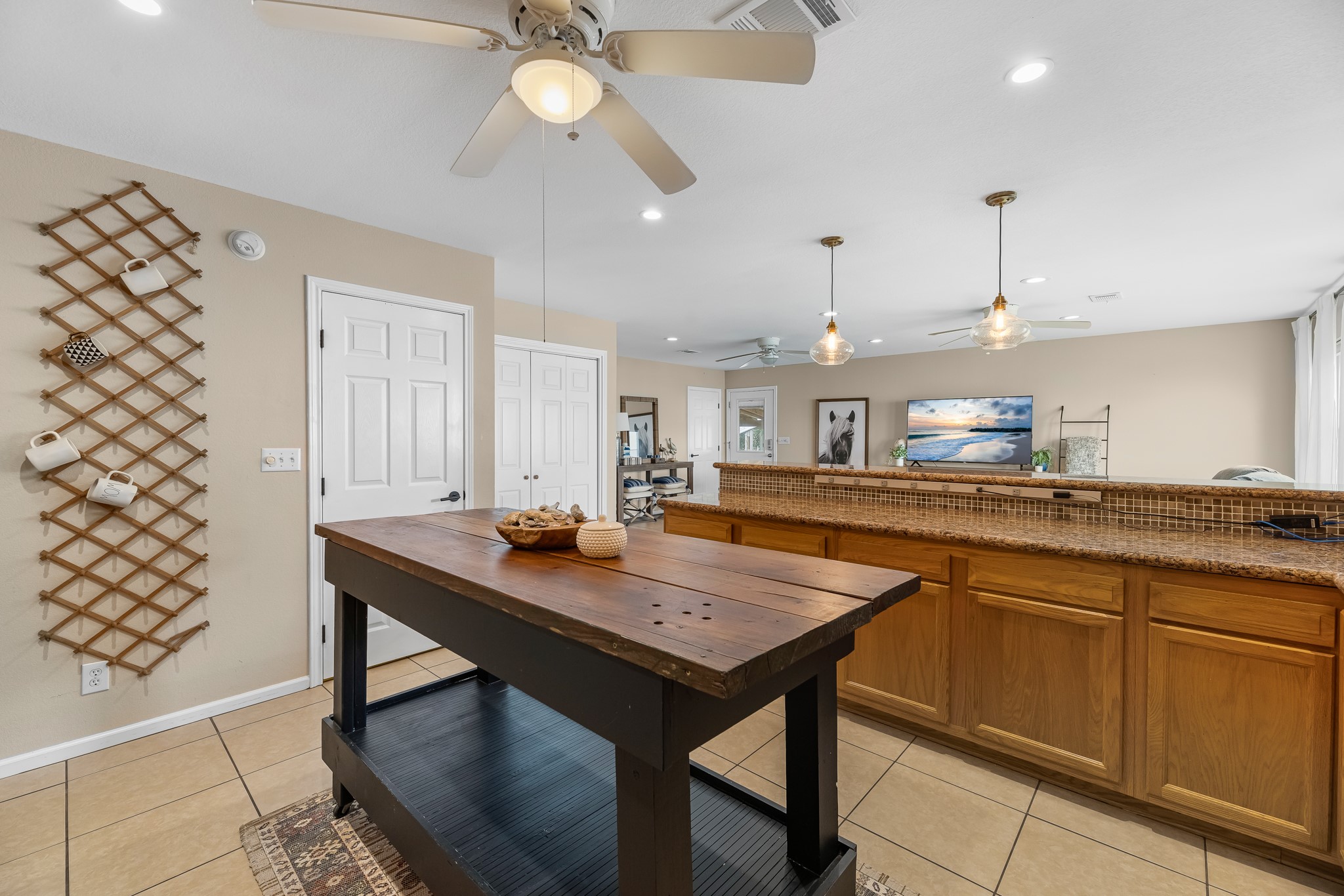 211 Captains Road Anahuac, TX 77514 - Photo 26 of 39 a kitchen with stainless steel appliances granite countertop a sink and a refrigerator