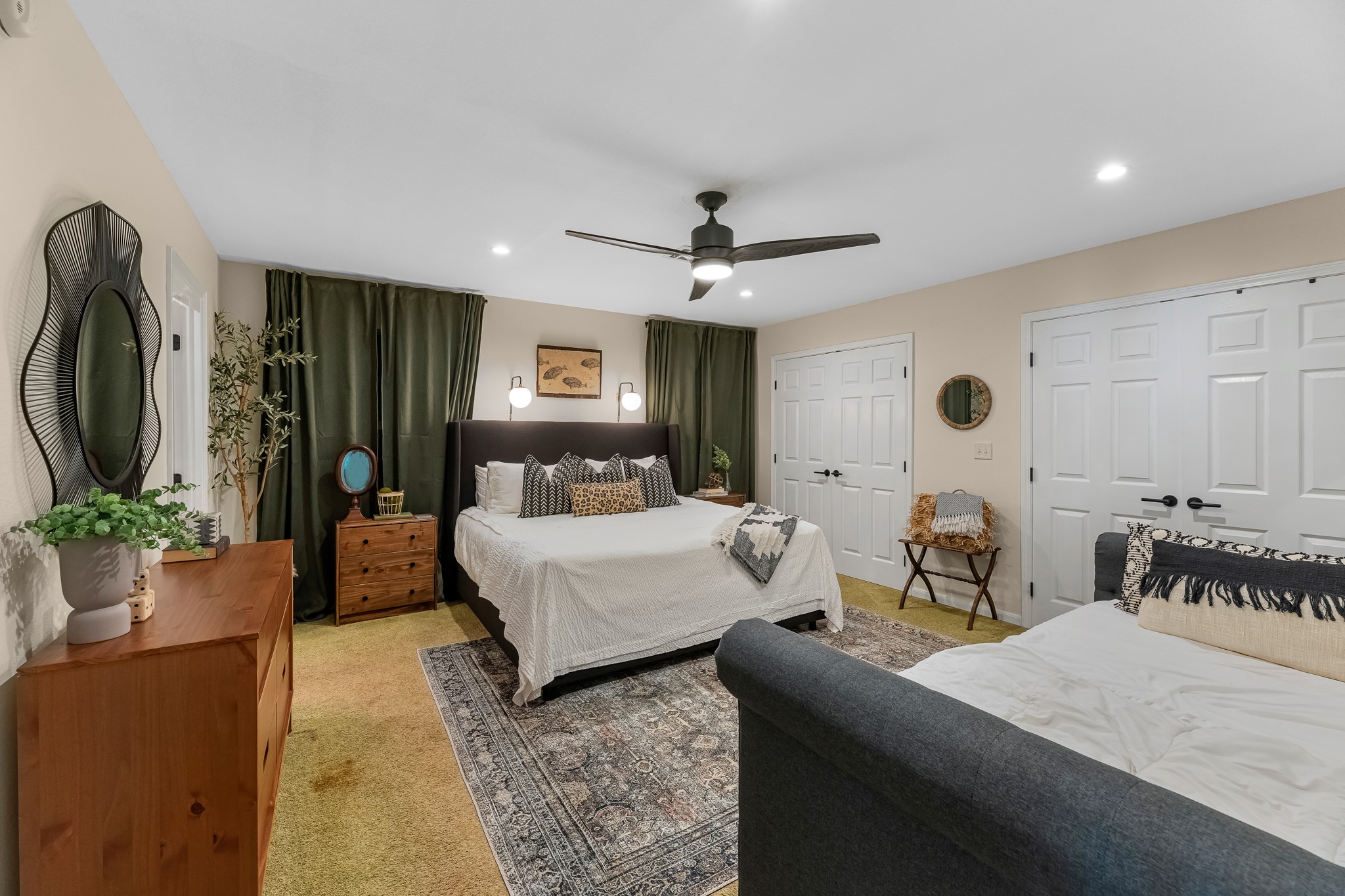 211 Captains Road Anahuac, TX 77514 - Photo 27 of 39 a bedroom with a bed a chandelier and a flat screen television