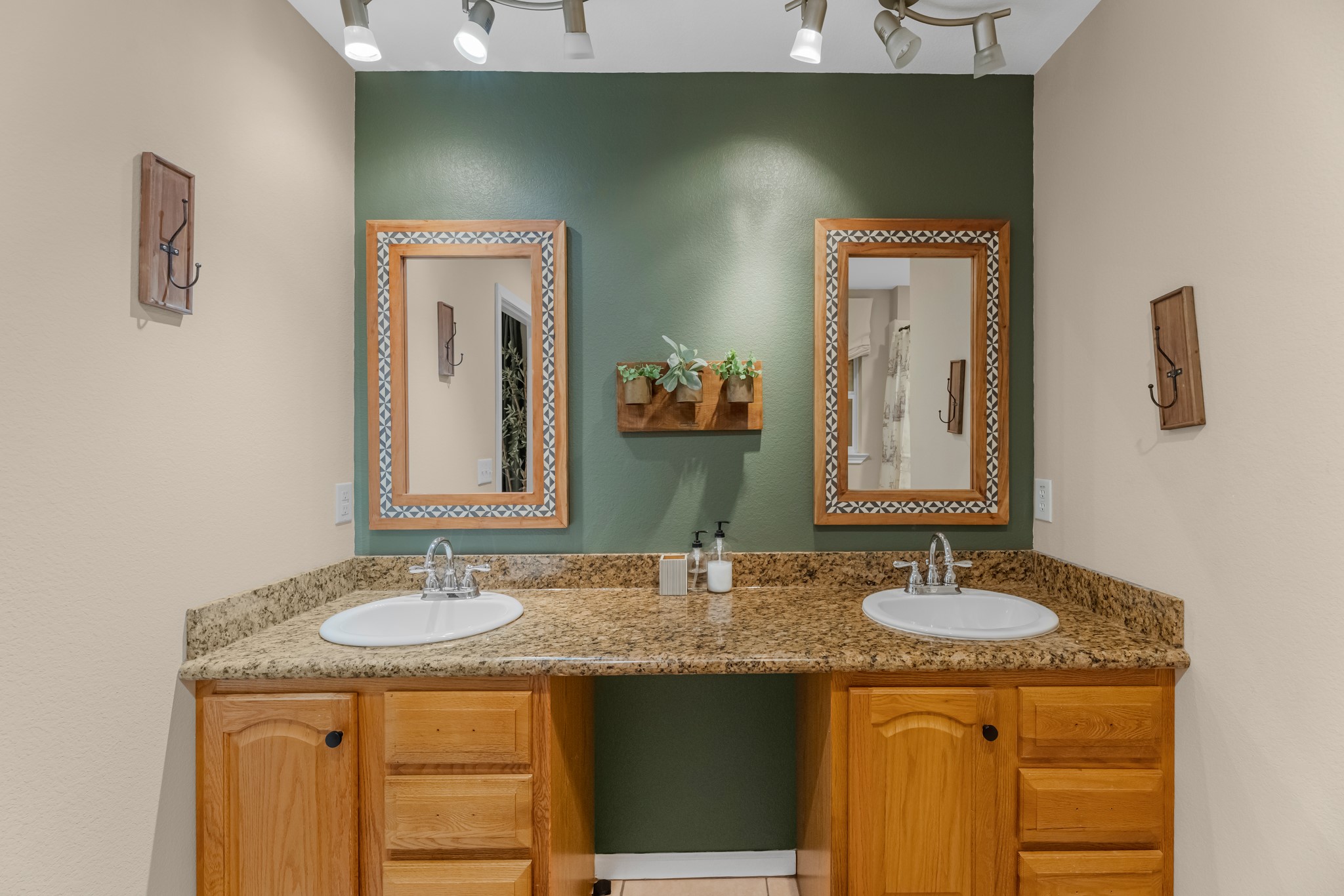 211 Captains Road Anahuac, TX 77514 - Photo 29 of 39 a bathroom with a granite countertop sink and a mirror