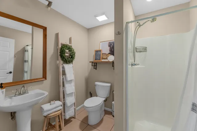 a bathroom with a toilet sink and shower