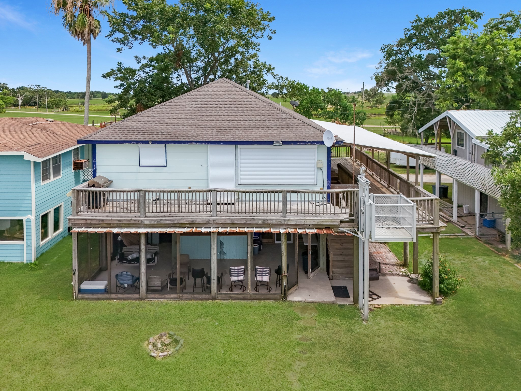 211 Captains Road Anahuac, TX 77514 - Photo 39 of 39 a view of a house with a big yard and large trees