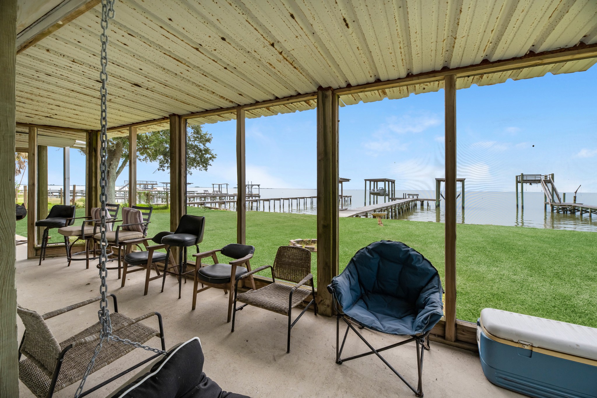 211 Captains Road Anahuac, TX 77514 - Photo 10 of 39 a living room with furniture and a floor to ceiling window