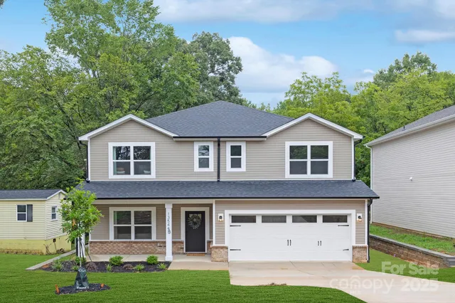 a front view of a house with a yard and garage