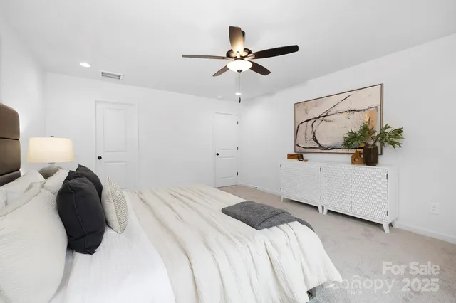 a bedroom with a bed and ceiling fan