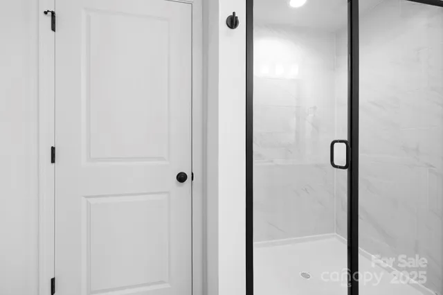 a bathroom with a glass shower door