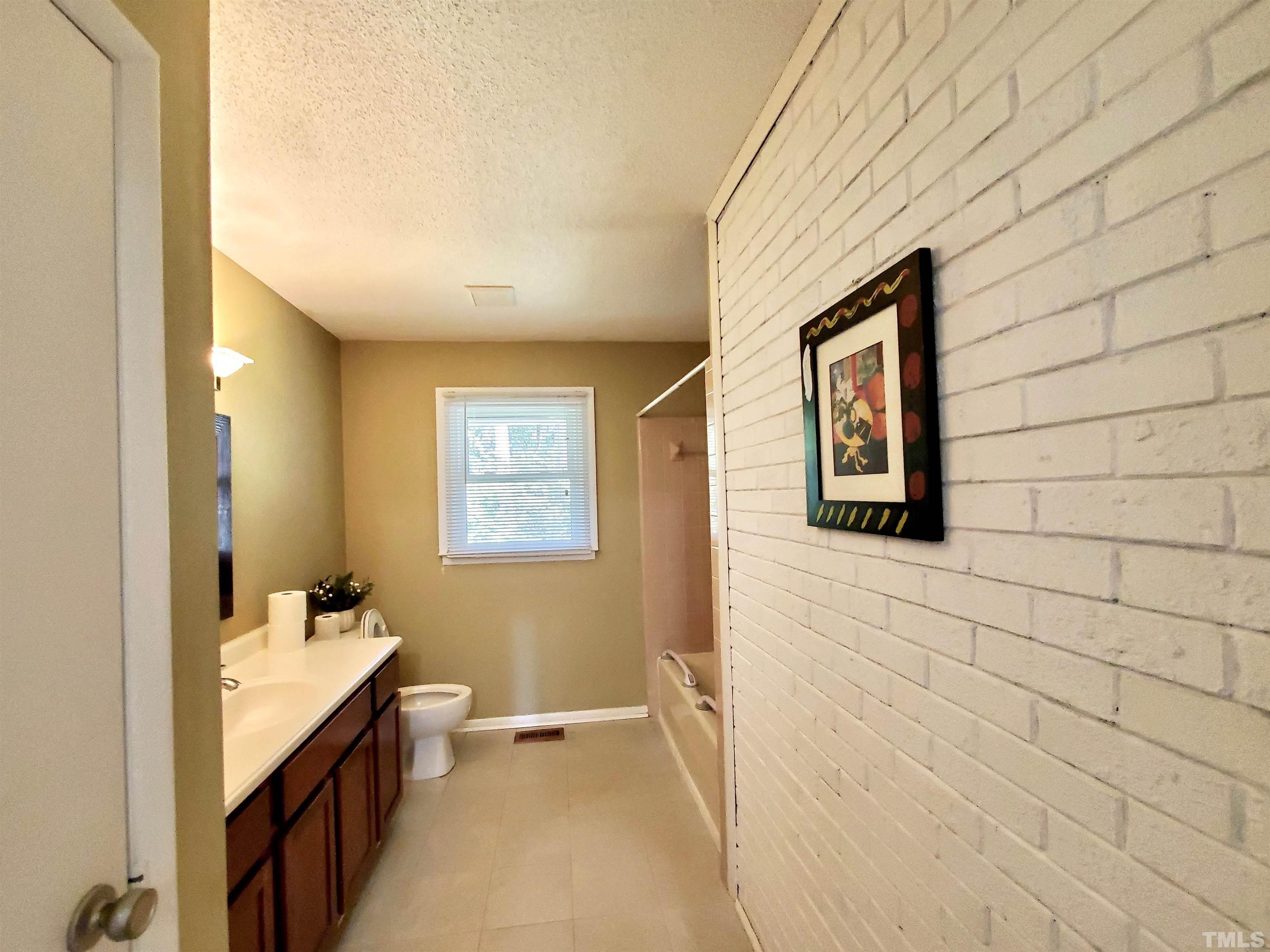 3505 Neptune Drive Raleigh, NC 27604 - Photo 13 of 28 a bathroom with a sink a toilet and mirror