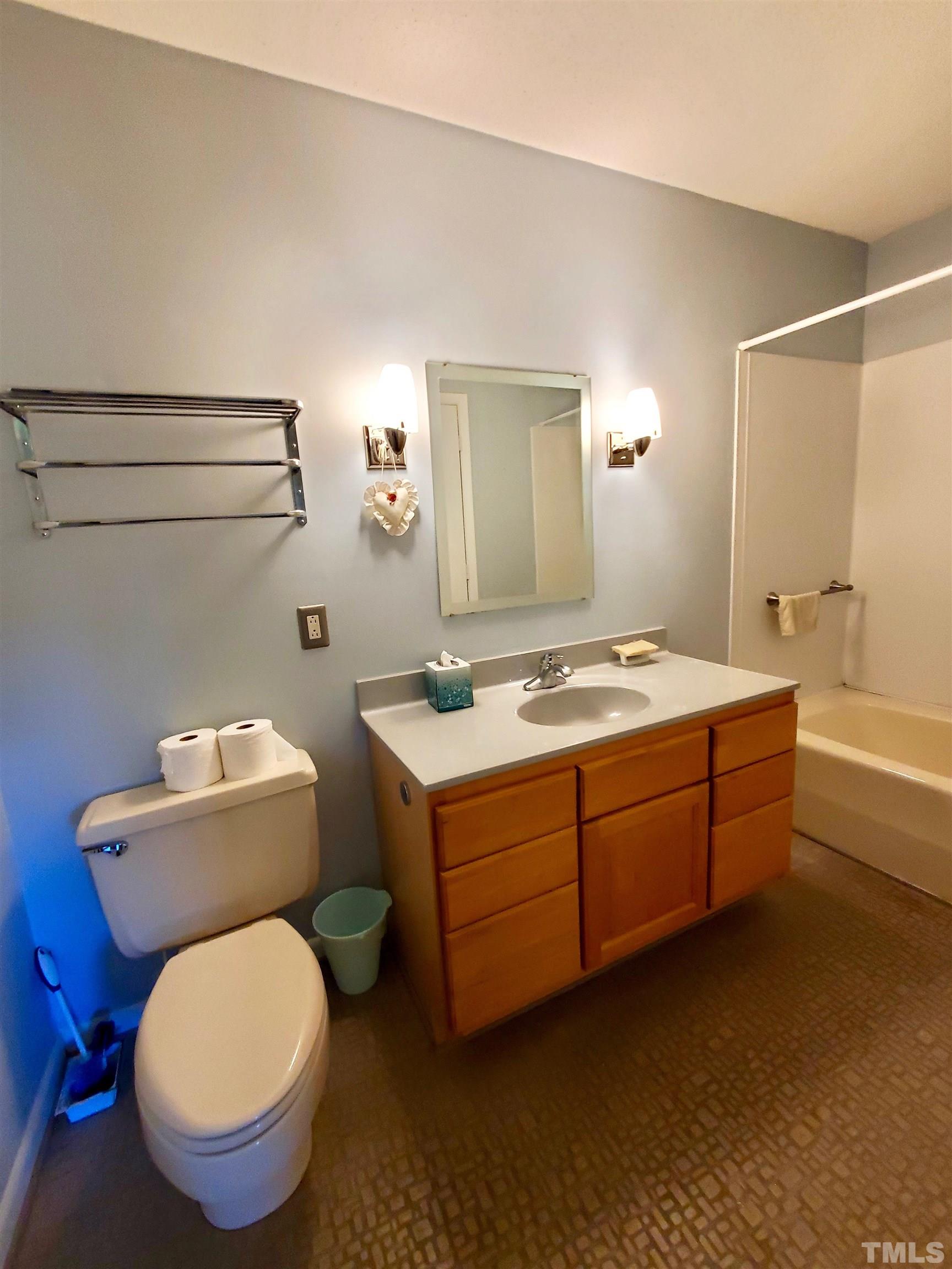 3505 Neptune Drive Raleigh, NC 27604 - Photo 14 of 28 a bathroom with a granite countertop toilet and a sink