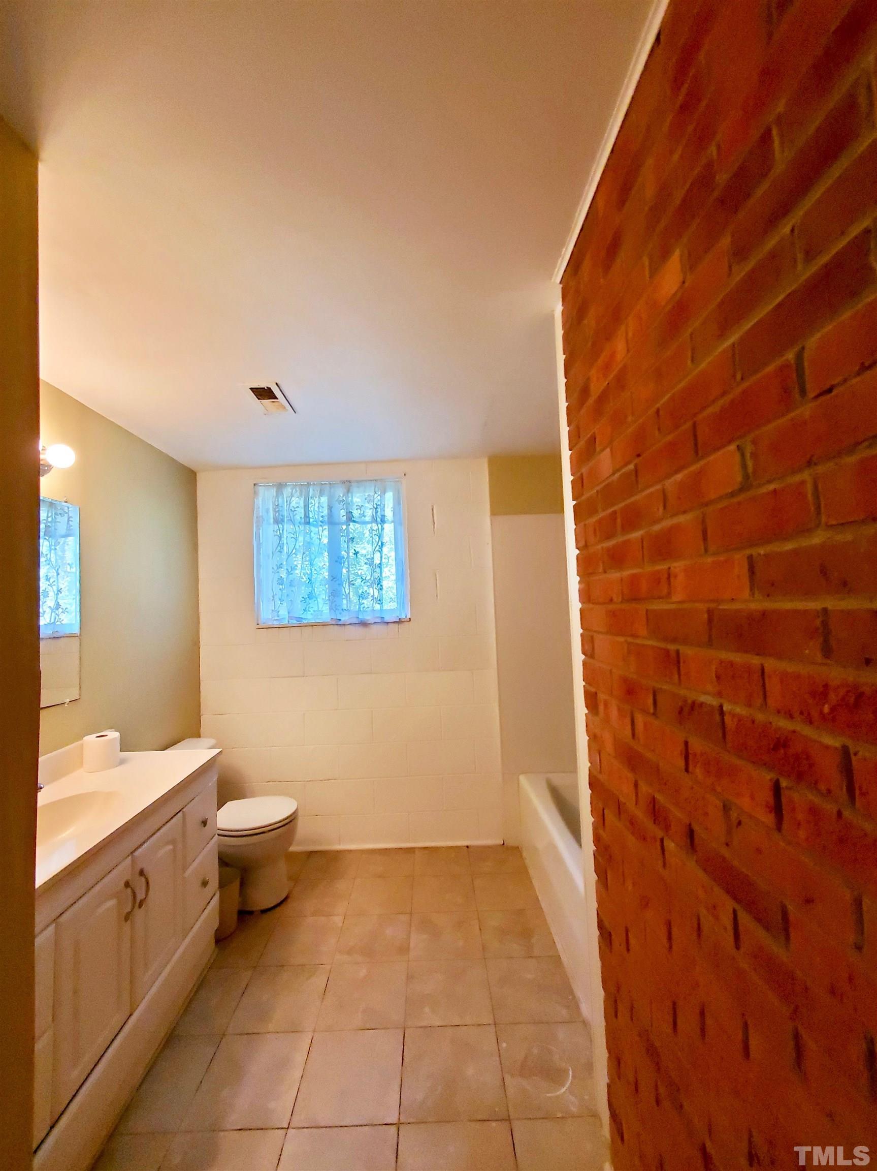3505 Neptune Drive Raleigh, NC 27604 - Photo 7 of 28 a bathroom with a toilet a sink and mirror