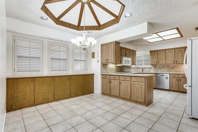 a kitchen with stainless steel appliances granite countertop a sink and cabinets
