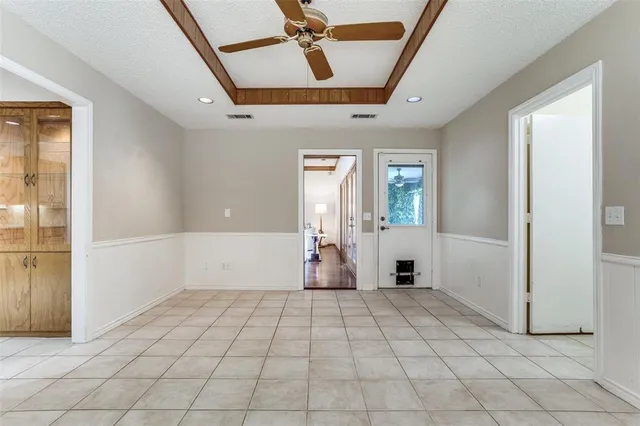 wooden floor in an empty room with a kitchen