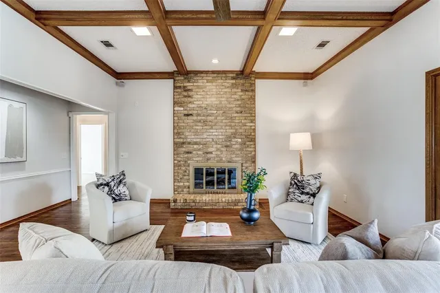 a living room with furniture wooden floor and a table