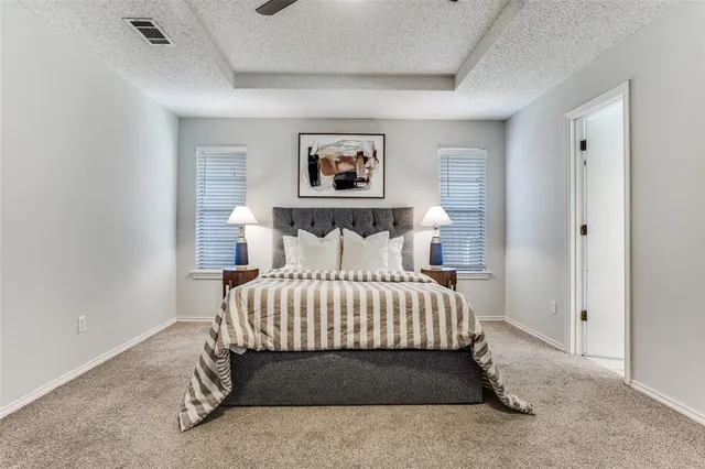 a bedroom with a bed and a painting on the wall