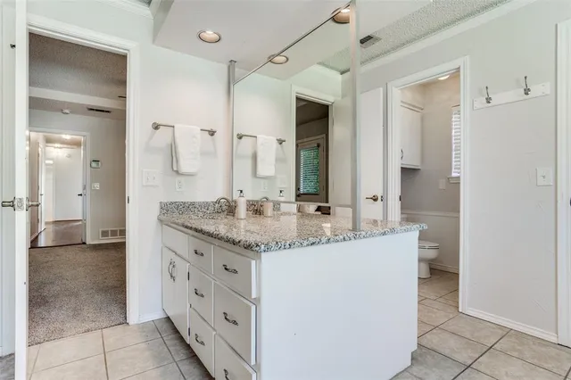 a bathroom with a toilet a sink and a mirror