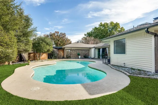 a view of a house with swimming pool and a yard
