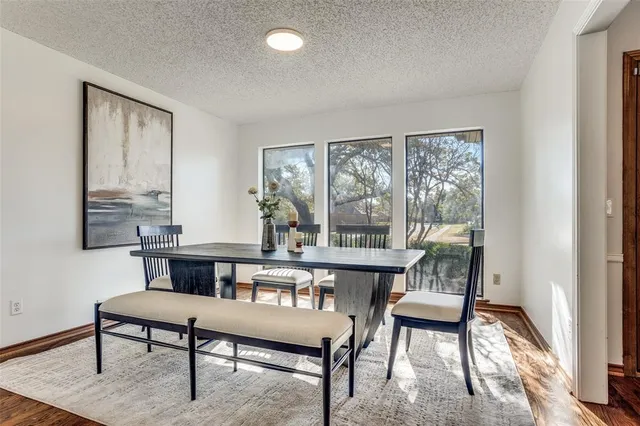 a living room with furniture a rug a lamp and a window
