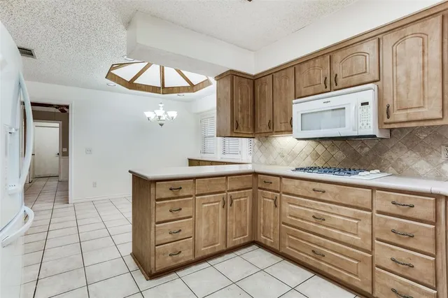 a kitchen with cabinets and window
