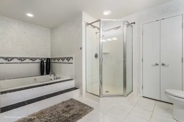 a bathroom with a glass shower door and a sink