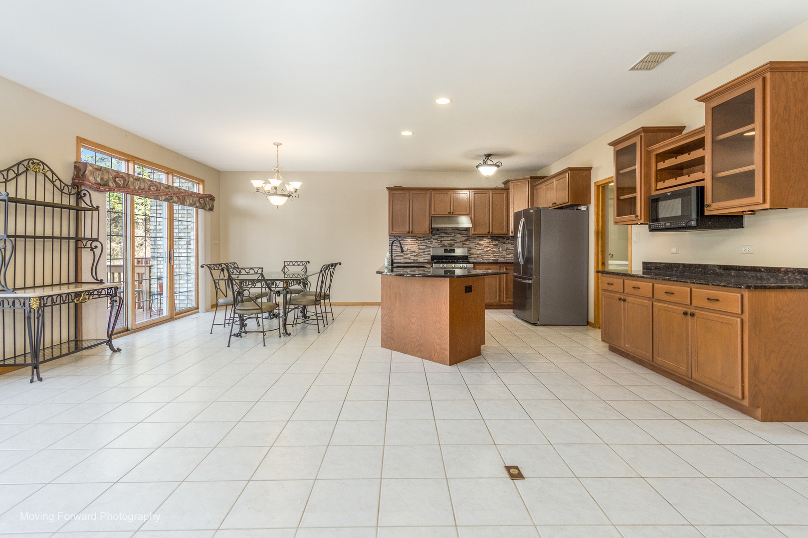 14825 Steven Court Lemont, IL 60439 - Photo 24 of 50 a kitchen with stainless steel appliances kitchen island granite countertop a refrigerator a stove a sink and white cabinets with wooden floor