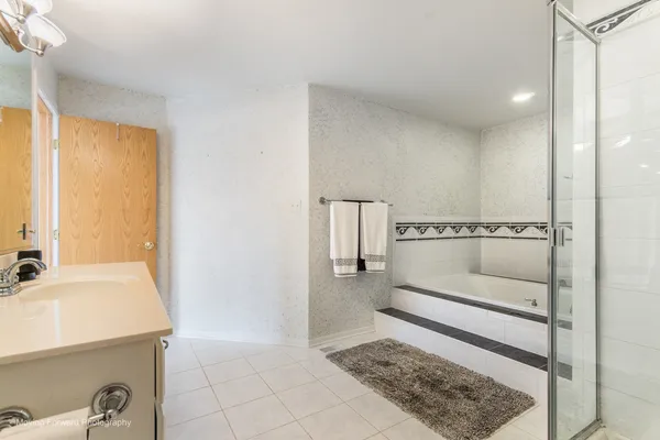 a bathroom with a bathtub and a shower
