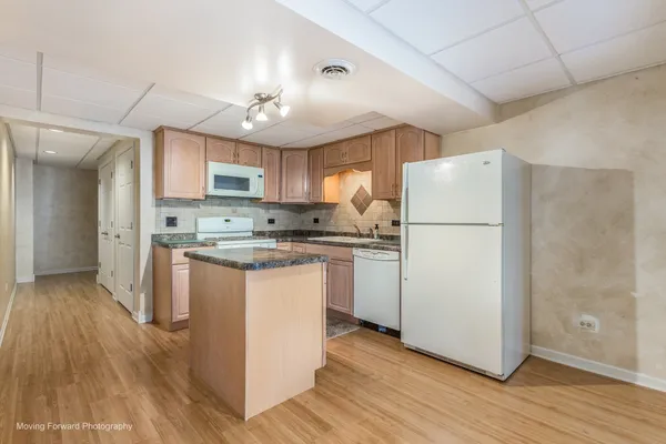 a kitchen with stainless steel appliances granite countertop a stove top oven a sink a counter top space and cabinets