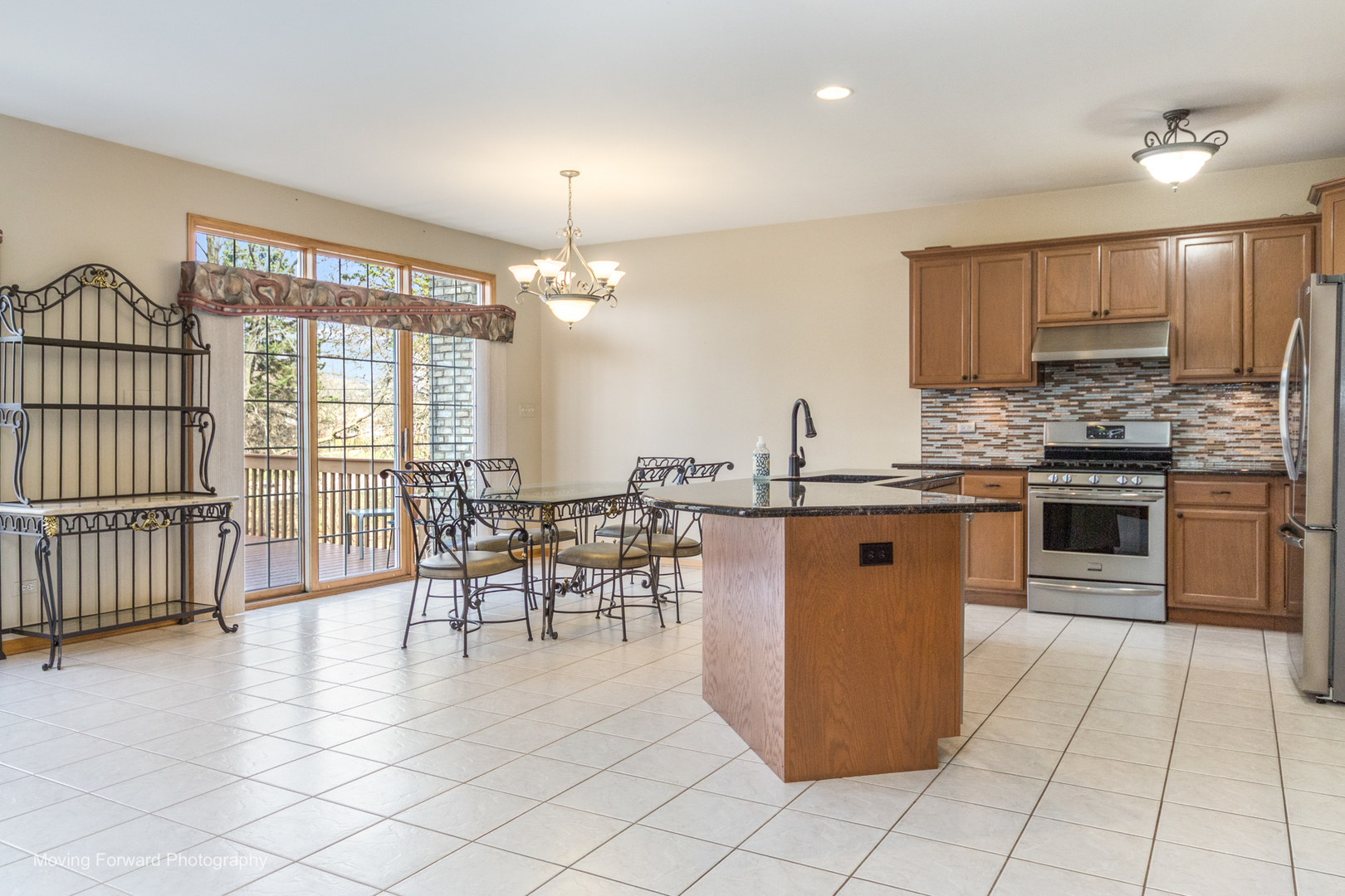 14825 Steven Court Lemont, IL 60439 - Photo 35 of 50 a kitchen with stainless steel appliances granite countertop a stove top oven a sink a counter top space and cabinets