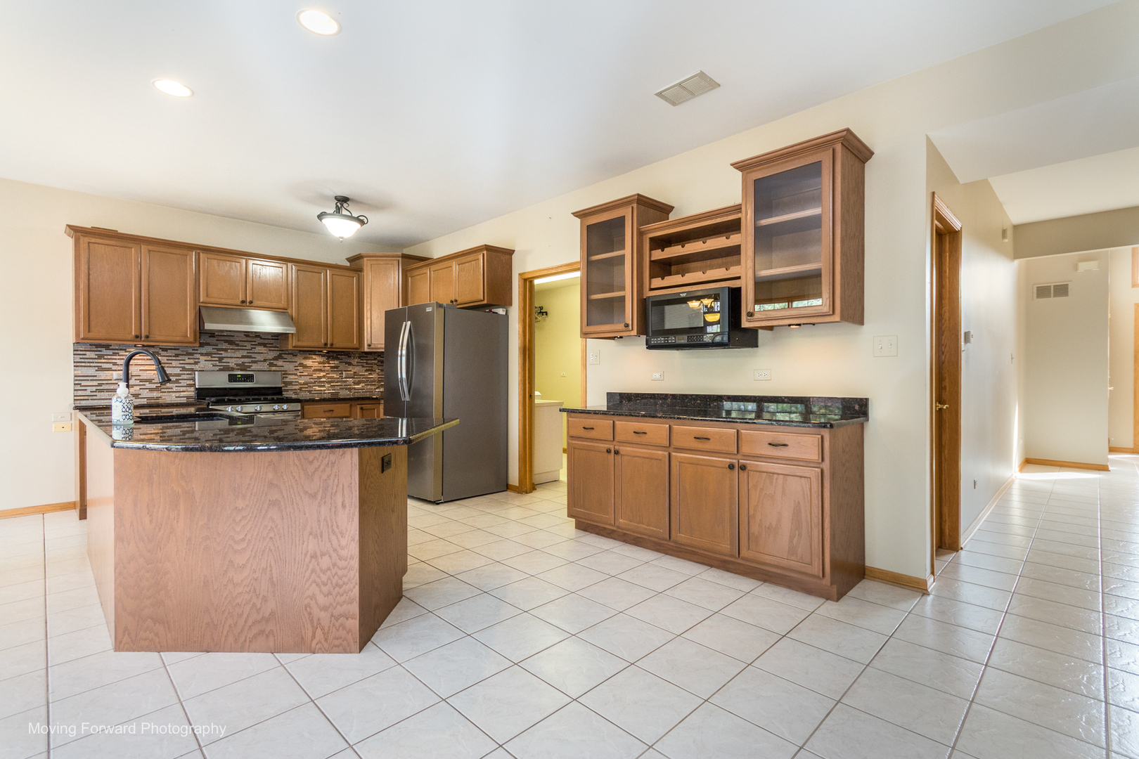 14825 Steven Court Lemont, IL 60439 - Photo 36 of 50 a kitchen with stainless steel appliances granite countertop a refrigerator and a stove
